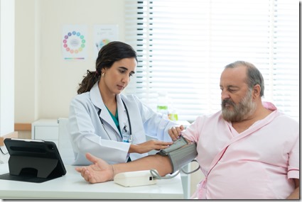 The doctor measures the patient's blood pressure. to see the progress of the patient's illness in the medical room